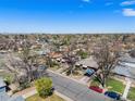Wide aerial shot showing neighborhood with mature trees and a clear blue sky at 2064 Ironton St, Aurora, CO 80010