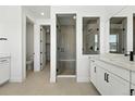 Contemporary bathroom showcasing a glass-enclosed shower, double vanity, and modern fixtures at 1733 Fox Trotter Pt, Castle Rock, CO 80104