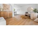 Bright, open-concept living room with hardwood floors, stylish furnishings, and seamless flow to the dining area at 3930 S Spruce St, Denver, CO 80237