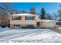 House exterior showcasing a snow covered front yard at 900 Emerald St, Broomfield, CO 80020