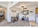 Open dining area includes a table set for two and a decorative accent cabinet with mirror at 10150 E Virginia Ave # 7-302, Denver, CO 80247