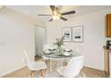 Cozy dining room with a glass-top table, modern white chairs, and stylish decor at 10150 E Virginia Ave # 7-302, Denver, CO 80247