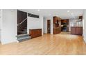 Living room with hardwood floors and stairs to upper level at 1442 S Logan St, Denver, CO 80210