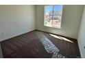 A carpeted bedroom with a large window providing lots of natural light at 25323 E Warren Pl, Aurora, CO 80018