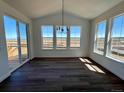 Bright dining area with hardwood floors, slider and large windows offering a nice view at 25323 E Warren Pl, Aurora, CO 80018