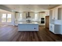 Modern kitchen featuring white cabinets, stainless steel appliances, and a center island at 25323 E Warren Pl, Aurora, CO 80018