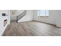 Open-concept living room showcasing hardwood floors, natural light, and staircase at 25323 E Warren Pl, Aurora, CO 80018