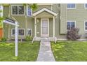 Charming covered front porch with number 5713, concrete steps, and a freshly cut lawn at 5713 Whitechapel St, Castle Rock, CO 80104