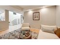 Inviting living room with a winding staircase, cozy seating, stylish rug, and bright lighting at 5745 W Mansfield Ave # 265, Denver, CO 80235
