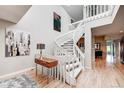 Staircase with unique design, carpeted stairs, hardwood floors, and stylish decor, filled with natural light at 5745 W Mansfield Ave # 265, Denver, CO 80235