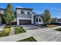 Modern two-story home featuring a well-manicured lawn and a convenient two-car garage at 18085 E 107Th Pl, Commerce City, CO 80022