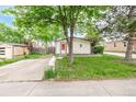 Attractive single-story home with a well-kept lawn and mature trees at 5532 Umatilla St, Denver, CO 80221