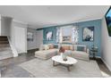 Bright living room with L-shaped sofa and tile flooring at 9359 W Lake Dr, Littleton, CO 80123