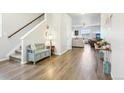 Bright foyer with hardwood floors, a bench, and views into the spacious living area at 1607 Goldfield Trl, Castle Rock, CO 80109