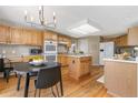 Spacious kitchen featuring wood cabinets, an island, and modern appliances at 957 Rosedale St, Castle Rock, CO 80104
