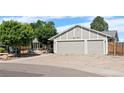 Charming single-Gathering home boasts a three-car garage and a well-maintained front yard at 16673 E Kent Dr, Aurora, CO 80013