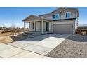 Attractive two-story home featuring a covered porch and a concrete driveway leading to the garage at 5918 Red Barn Ave, Mead, CO 80504