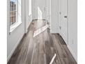 Bright entryway showcasing hardwood flooring, white walls, and natural light from nearby windows at 9501 Richfield St, Commerce City, CO 80022