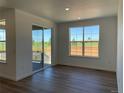 Bright dining room featuring wood floors, and a sliding glass door to the patio at 737 Raindance St, Erie, CO 80516