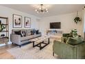 Stylish living room featuring modern decor, comfortable seating, a glass coffee table, and a contemporary light fixture at 6642 S Pearl St, Centennial, CO 80121