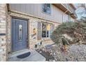 Townhome's front entrance with brick facade and landscaping at 1770 Robb St, Lakewood, CO 80215