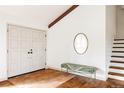 Bright foyer features double doors, geometric tile, a statement mirror, and staircase at 3624 S Poplar St, Denver, CO 80237