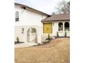 Inviting front entrance with bright yellow double doors, arched entry, and manicured landscaping at 3624 S Poplar St, Denver, CO 80237