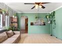 Inviting living room featuring light wood floors, fresh green walls, and an arched entryway at 8991 Hickory Pl, Thornton, CO 80229