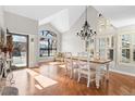 Bright dining room with hardwood floors, large windows, and modern chandelier, perfect for entertaining at 4321 Old Windmill Way, Castle Rock, CO 80109