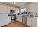 Kitchen boasts stainless steel appliances and granite countertops at 614 Glenwood Dr, Lafayette, CO 80026