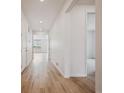 Bright hallway featuring hardwood floors, neutral paint, and access to multiple rooms at 24740 E 39Th Ave, Aurora, CO 80019