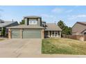Charming two-story home featuring a spacious front yard and a two-car garage at 5149 S Genoa Ct, Centennial, CO 80015