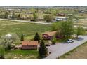 Lovely aerial view showcasing the single-Gathering home, shed, mature trees, and private driveway at 6310 W County Road 4, Berthoud, CO 80513