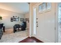 Bright entryway features decorative glass door panels, hardwood floors, and adjacent home office at 3630 Gold Bug St, Aurora, CO 80019