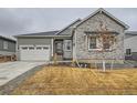 Charming home with stone accents, a well-manicured lawn and a welcoming front entrance, creating a warm curb appeal at 3630 Gold Bug St, Aurora, CO 80019