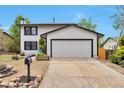 Traditional white house with a spacious two-car garage and a well-maintained driveway at 3575 S Ouray St, Aurora, CO 80013