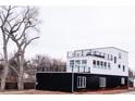 Modern black and white two-story home featuring a rooftop deck and clean lines at 5462 S Cedar St, Littleton, CO 80120