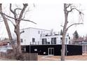 A modern home with black and white exterior, multiple balconies providing outdoor space and neighborhood views at 5462 S Cedar St, Littleton, CO 80120