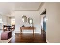 A bright foyer with hardwood floors, stylish console table, and a view of the dining area at 3501 W 41St Ave, Denver, CO 80211