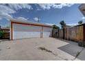 Detached two-car garage featuring ample parking space and convenient access, surrounded by a wood fence at 10900 Mildred Dr, Northglenn, CO 80233