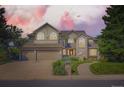 Beautiful two-story home with a three-car garage, arched windows, and a well-manicured lawn at 9096 E Colorado Cir, Denver, CO 80231