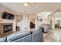 Inviting living room features a cozy fireplace, comfortable seating, and views into the main bedroom at 16320 E Fremont Ave # 1, Aurora, CO 80016