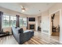 Bright living room with large windows, fireplace, stylish furnishings, and modern flooring at 16320 E Fremont Ave # 1, Aurora, CO 80016