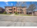 Condominium complex showcases reserved parking and traditional architecture at 205 Wright St # 104, Lakewood, CO 80228