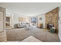 Comfortable living room with stone fireplace and sliding door to outdoors at 205 Wright St # 104, Lakewood, CO 80228