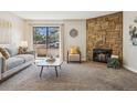 Inviting living room featuring a stone fireplace and sliding glass doors to outdoor space at 205 Wright St # 104, Lakewood, CO 80228