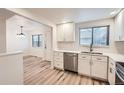 Updated kitchen boasts stainless steel appliances, white cabinets, and durable countertops at 12010 E Harvard Ave, Aurora, CO 80014