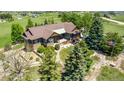 Gorgeous aerial view of an estate home with mature trees and American flag at 1505 Legacy Trl, Elizabeth, CO 80107