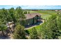Aerial view of a two-story home with a sprawling green yard and a private balcony at 1505 Legacy Trl, Elizabeth, CO 80107