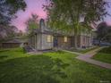 Charming brick home featuring a well-manicured lawn and mature tree at 1720 S Ammons St # A, Lakewood, CO 80232
